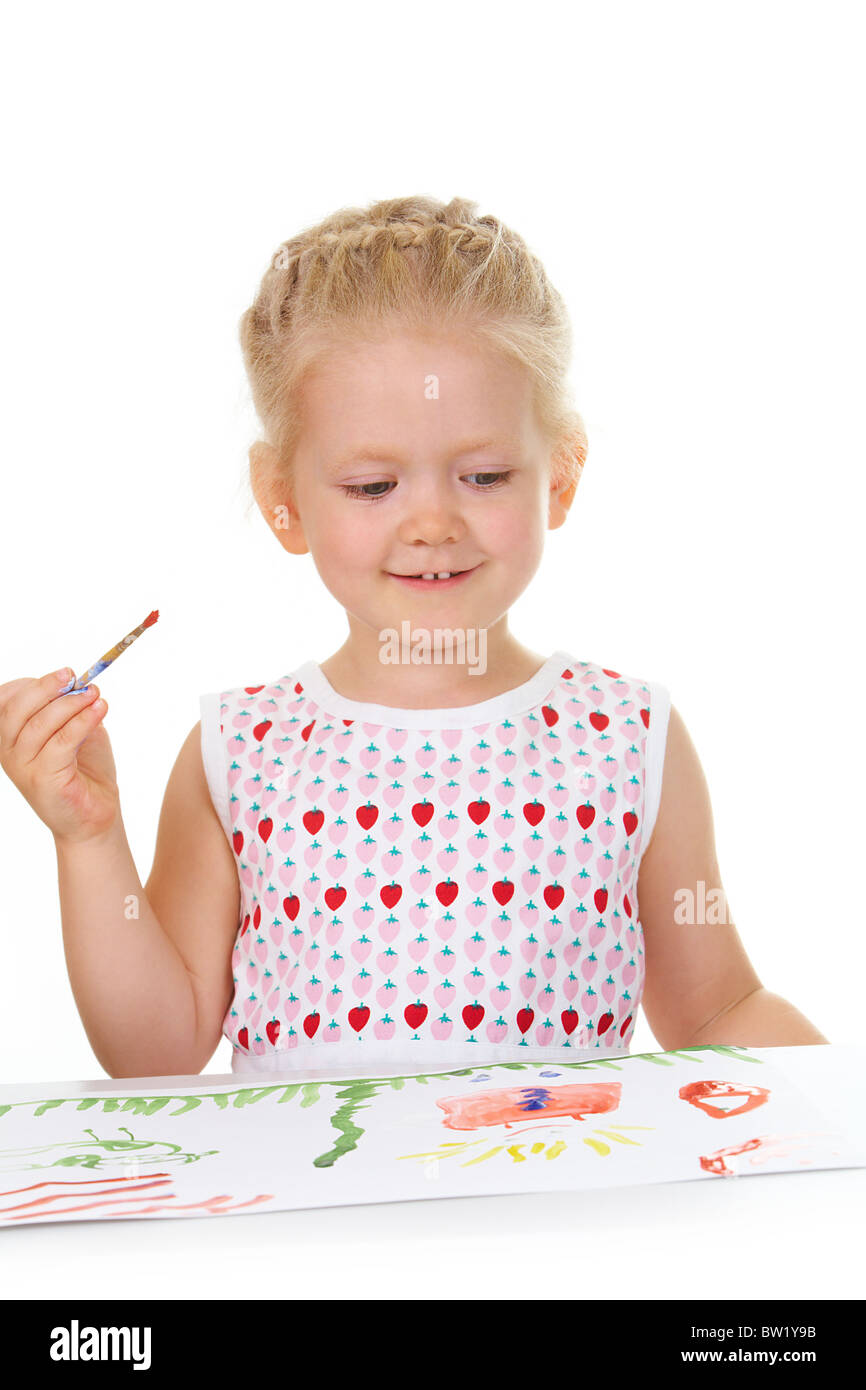 Photo of adorable girl painting with aquarelle and looking at her ...