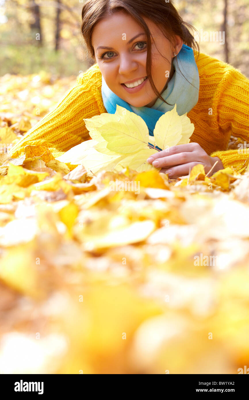 Image of resting young woman lying on foliage in autumn Stock Photo - Alamy