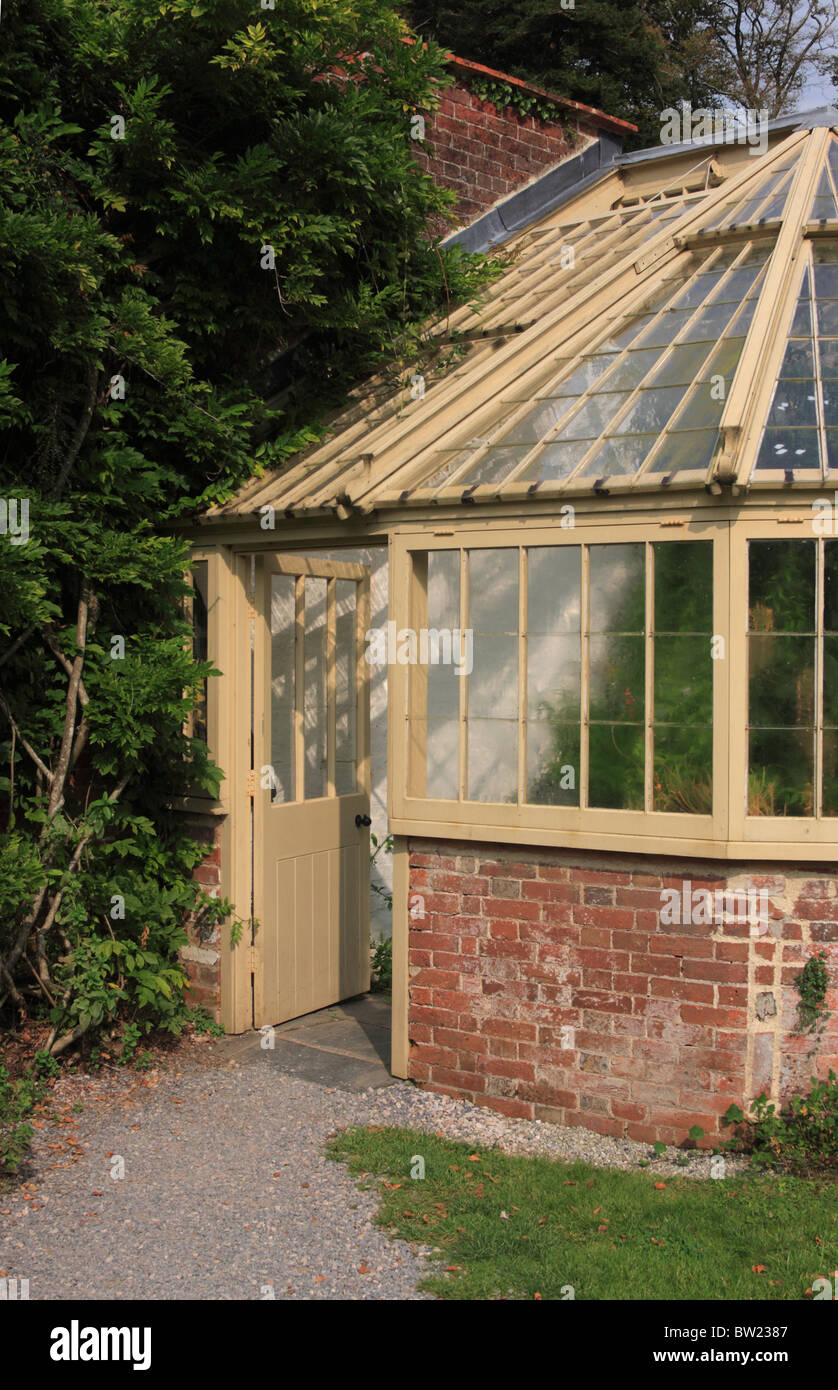 wood and brick greenhouse in gardens at Greenway house former home of