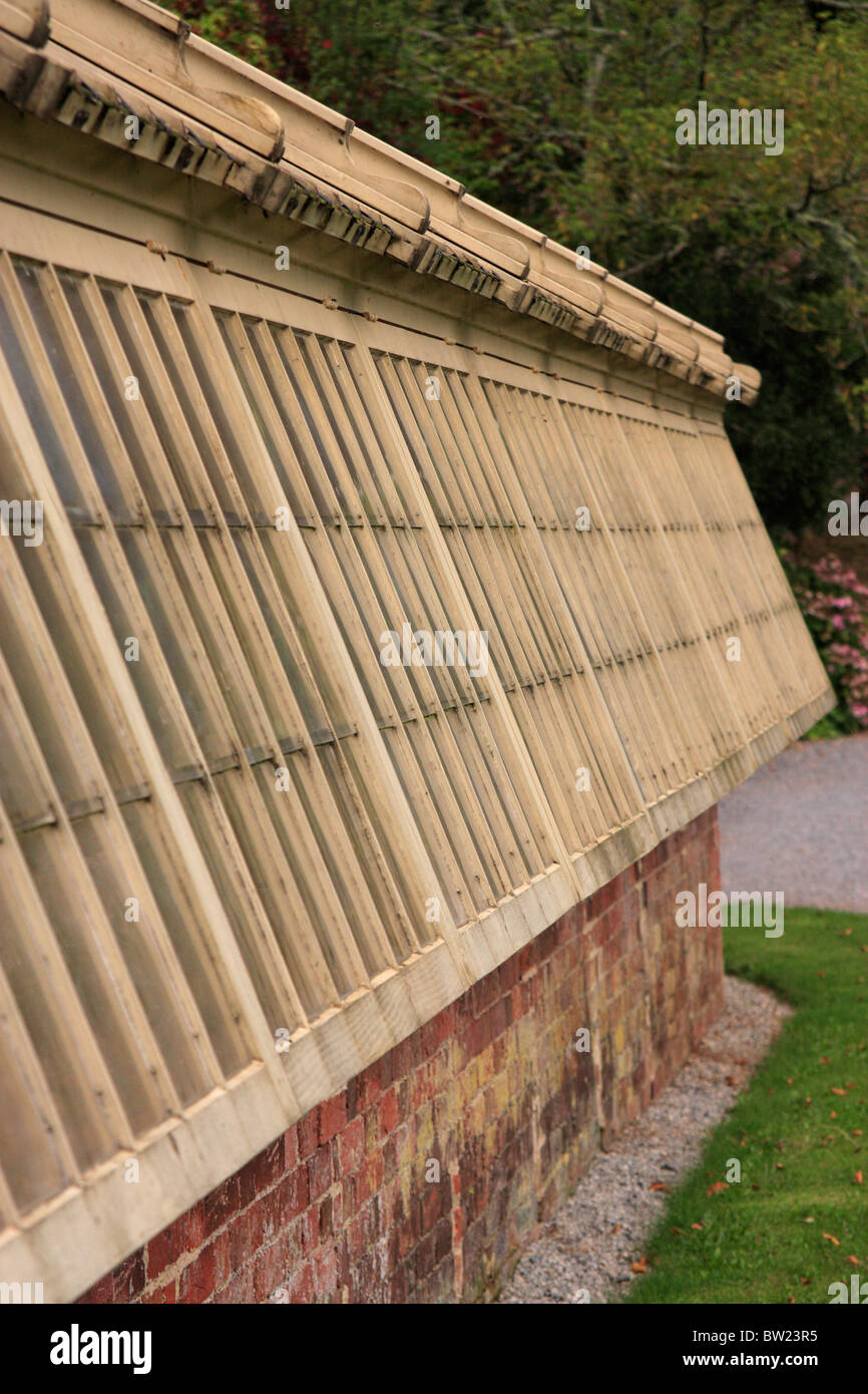 wood and brick greenhouse in gardens at Greenway house former home of