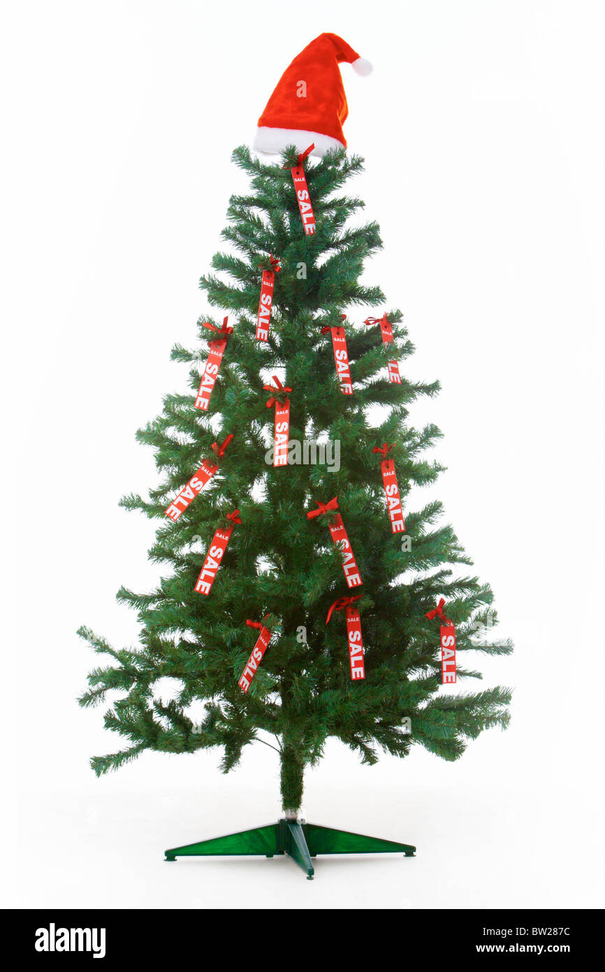 image of christmas fir tree decorated with red labels of sale and santa cap on its top - Decorative Christmas Labels image of christmas fir tree decorated with red labels of sale and santa cap on its top - Decorative Christmas Labels