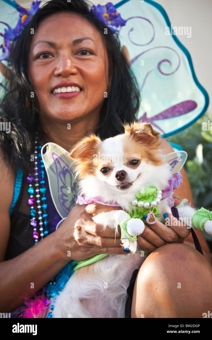 A costumed participant with her dog during the Pet Masquerade at the