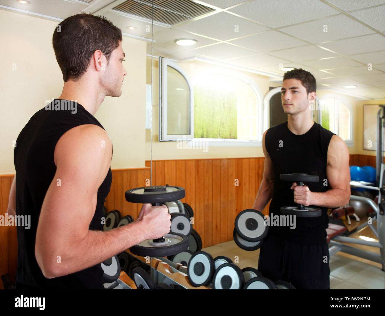 Gym young man posing body building weight black Stock Photo