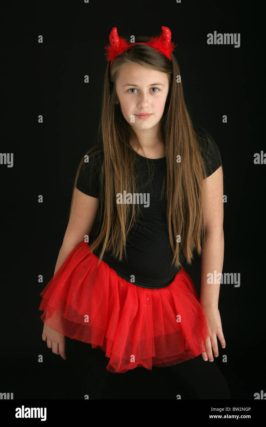 Pretty ten year old girl wearing a devil fancy dress costume. Stock Photo