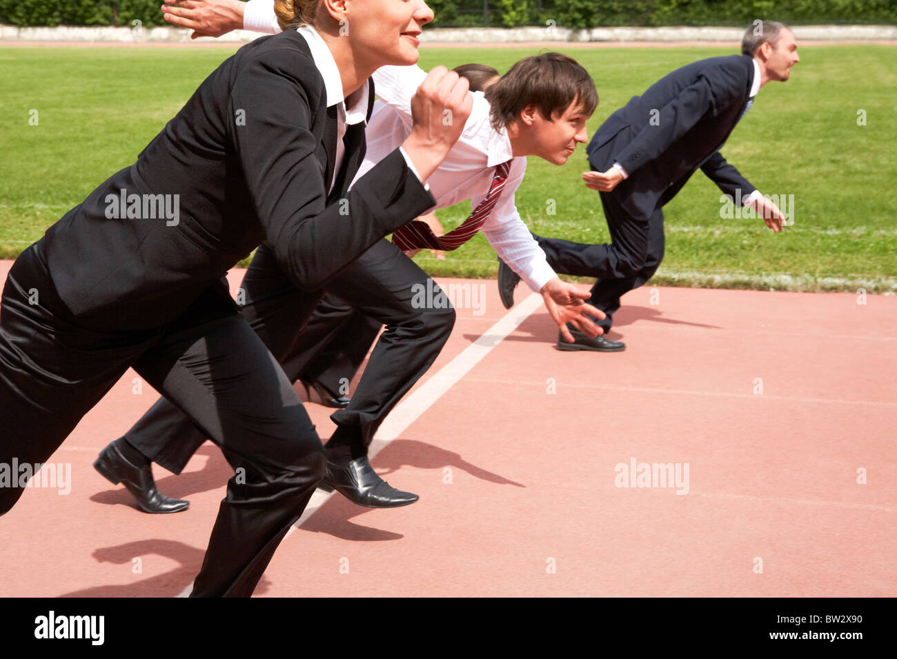 Image of active employees running on sport track Stock Photo