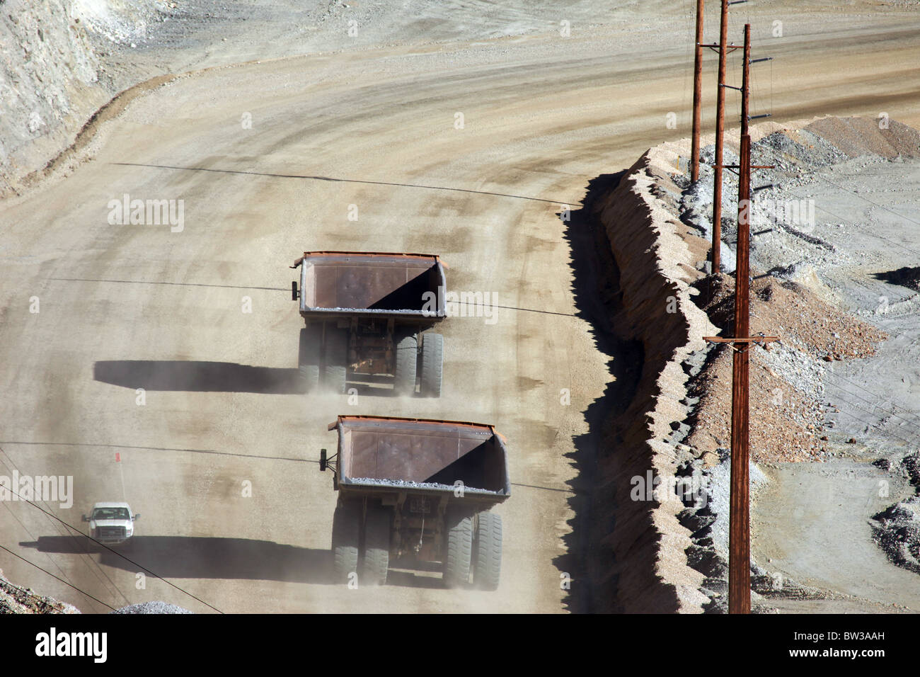 Two large mine dump trucks passing each other in Kennecott Copper Mine