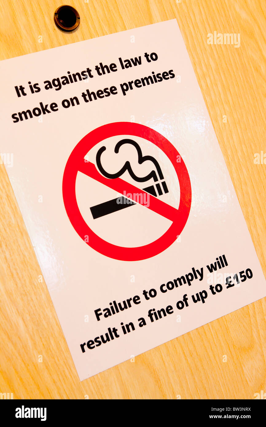 It Is Against The Law To Smoke On These Premises notice on a door in a public place in the United Kingdom after smoking ban Stock Photo