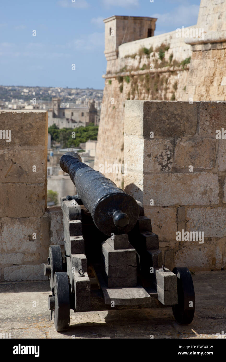 A medieval cannon poking out of the battlement at the Citadel in Gozo in Malta. Stock Photo