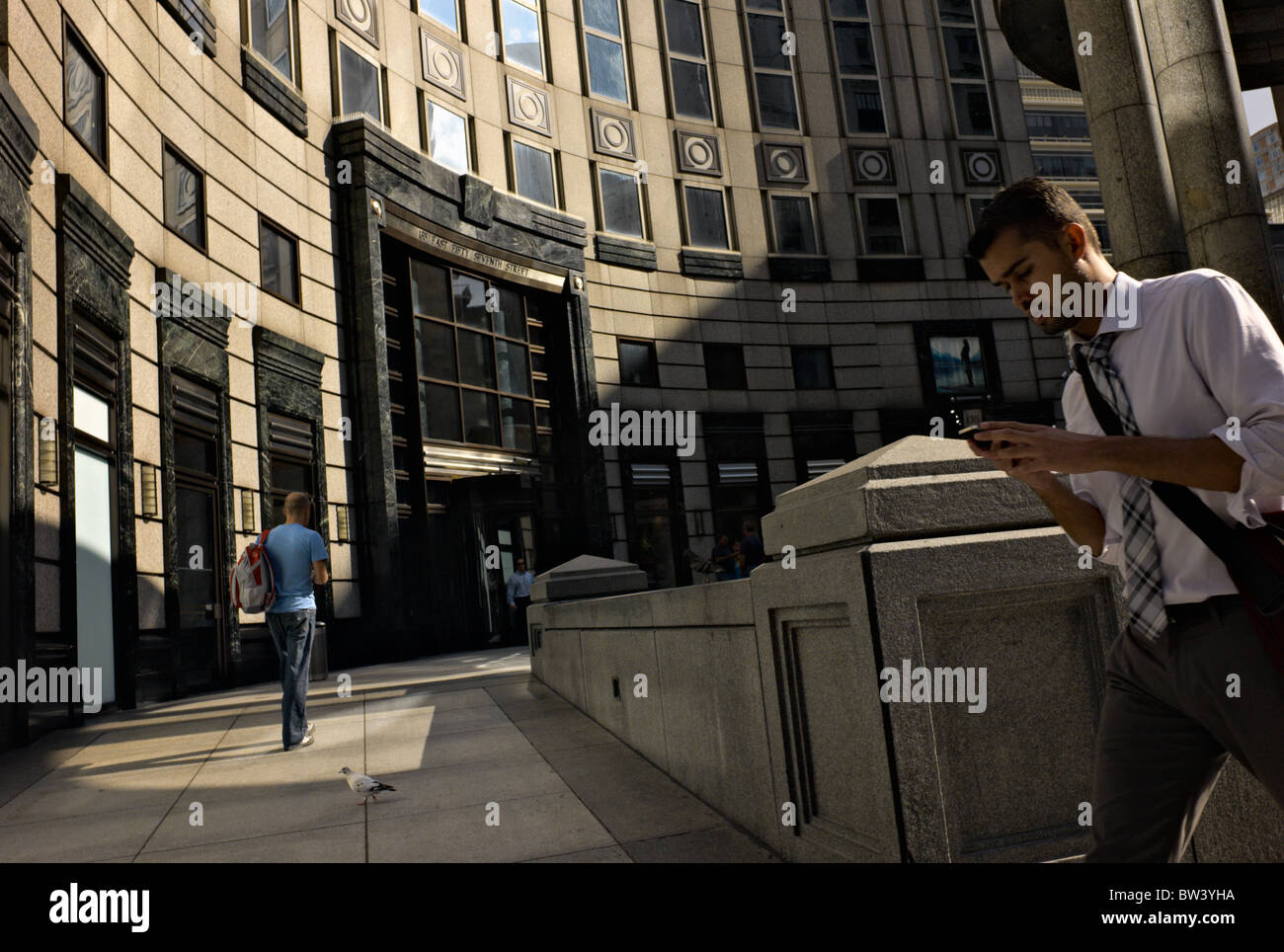 Man walking while using portable electronic device Stock Photo Alamy