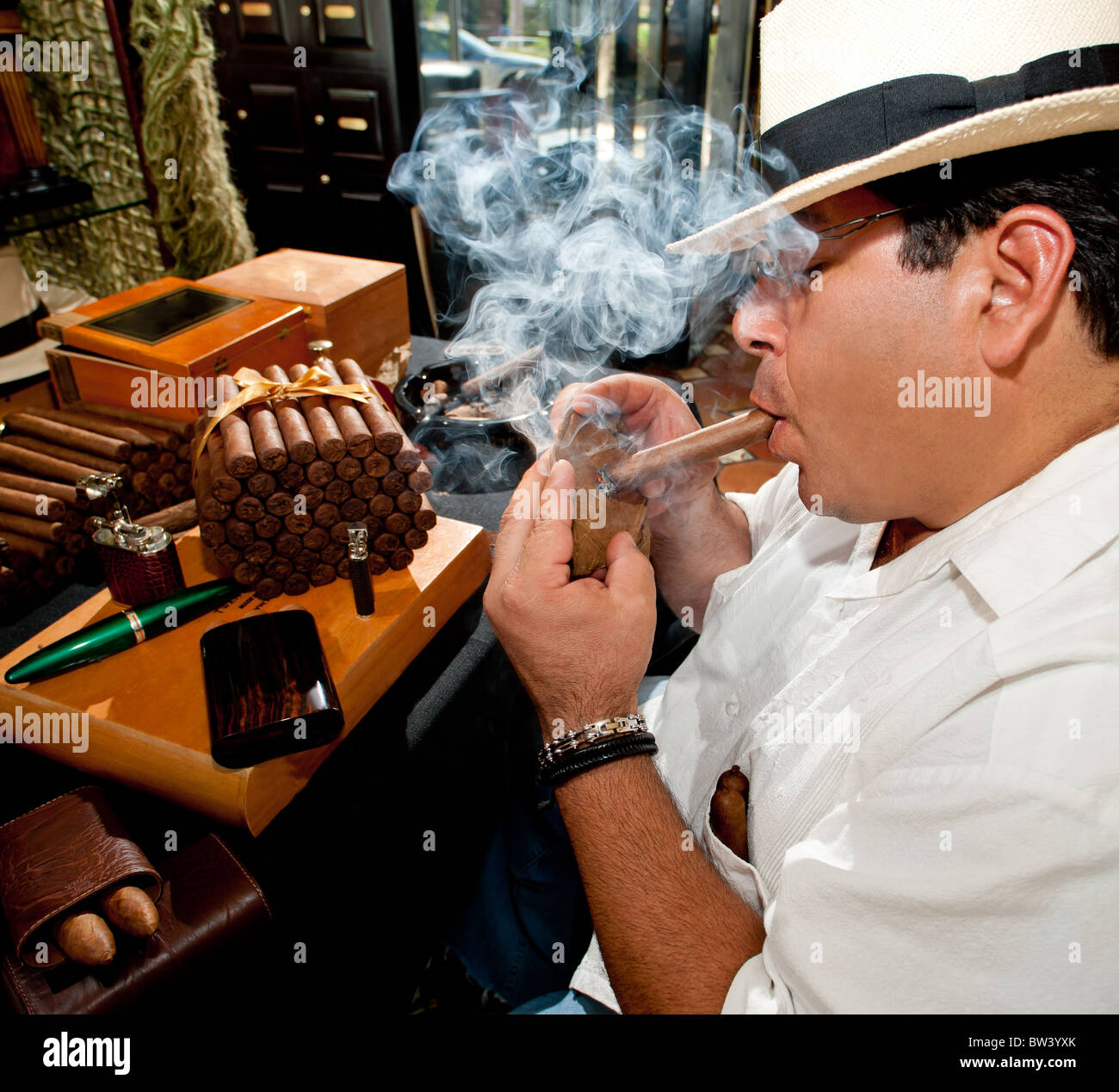 Adult Male Testing Cigar Wrapper with Lit Cigar Stock Photo