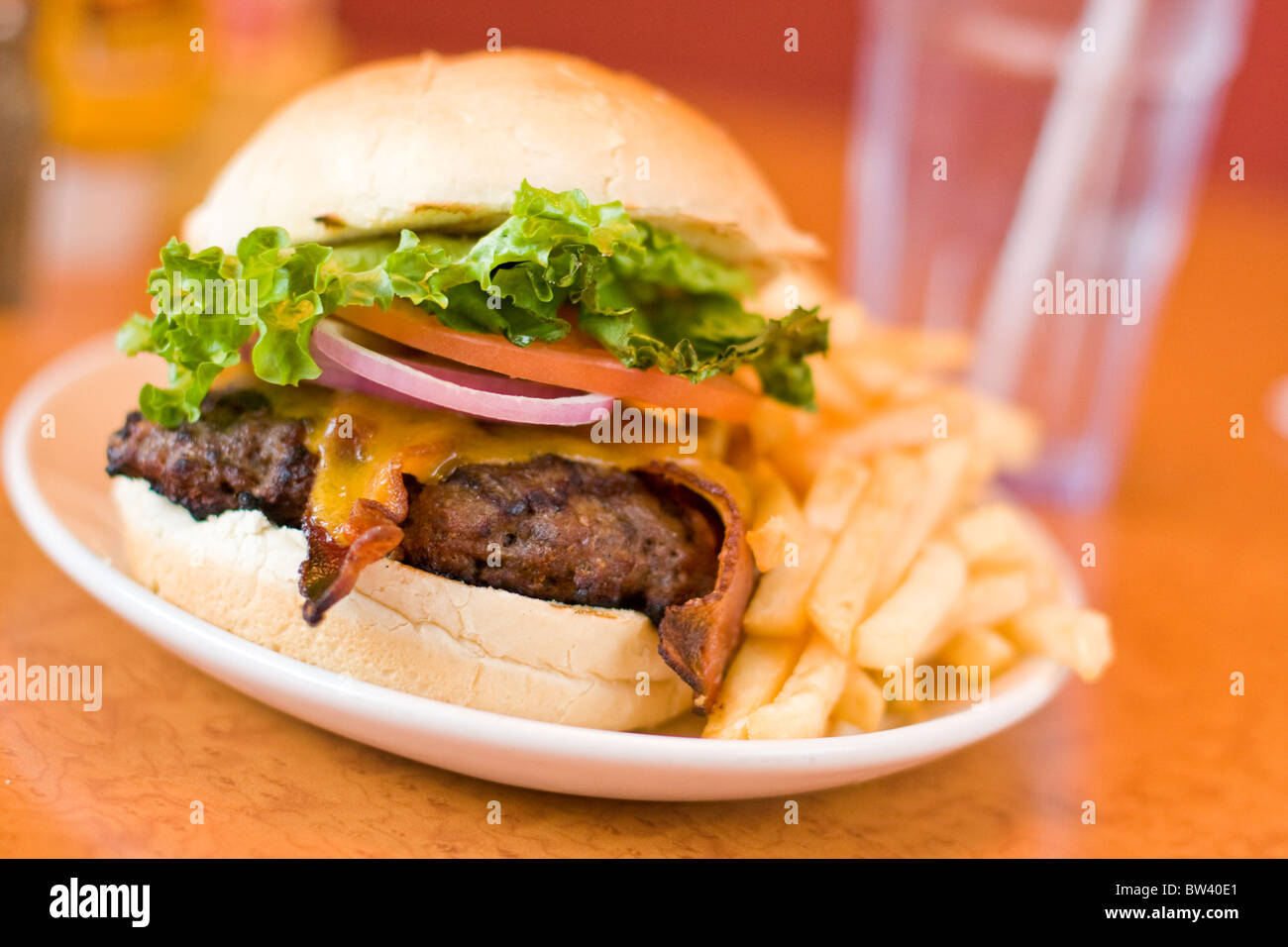 Cheese burger and fries on plate table top selective focus Stock Photo
