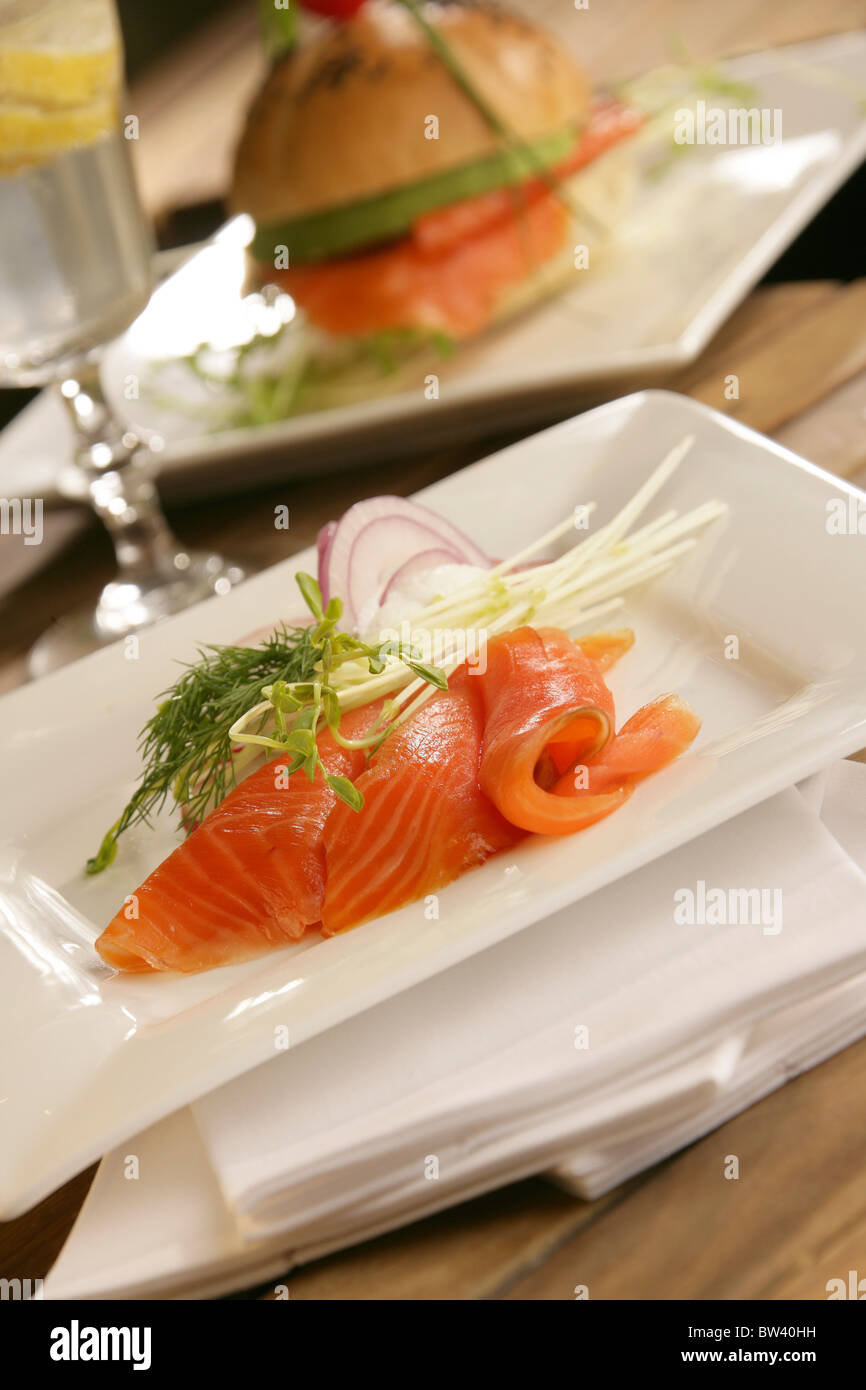 Plated Salmon dish, selective focus, Salmon burger and glass Stock Photo
