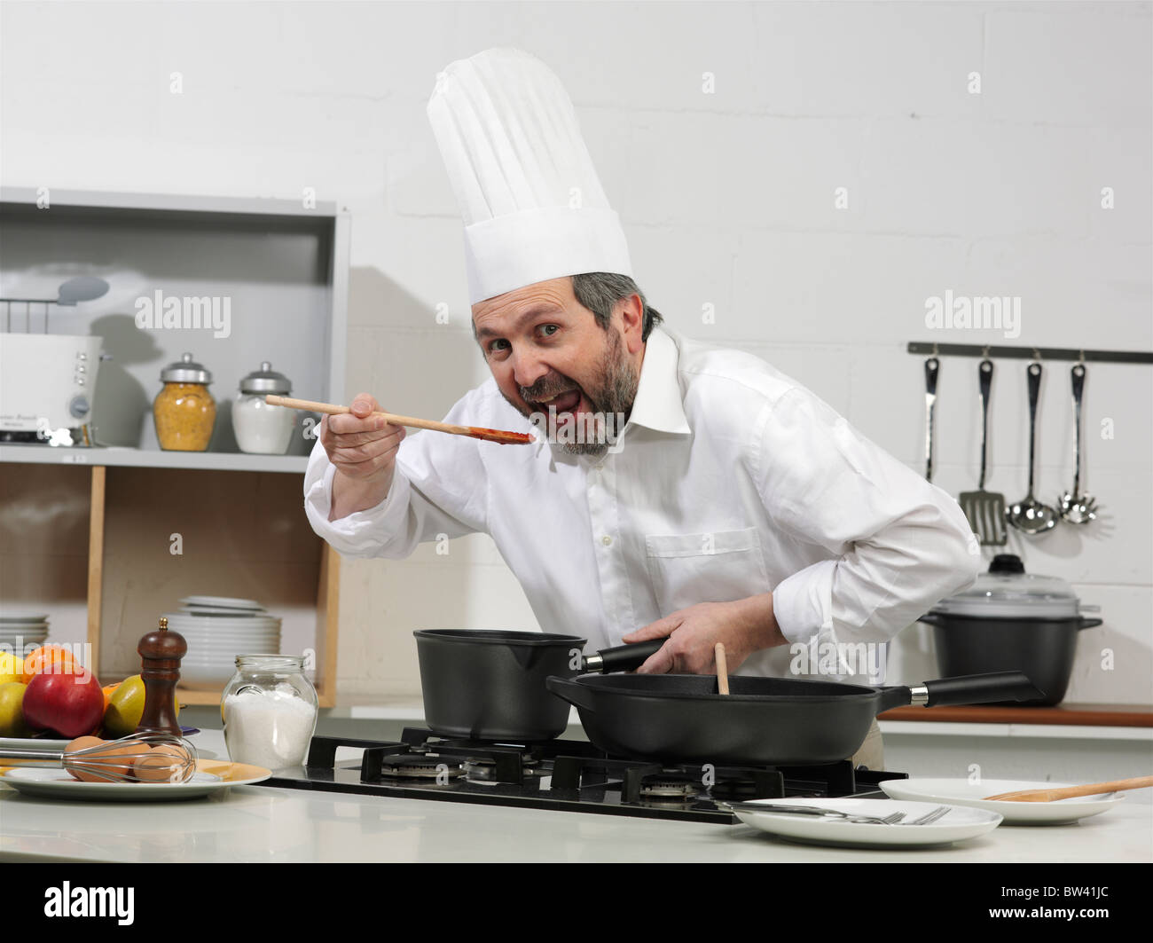 Cook in a kitchen, making a delicious dish Stock Photo - Alamy