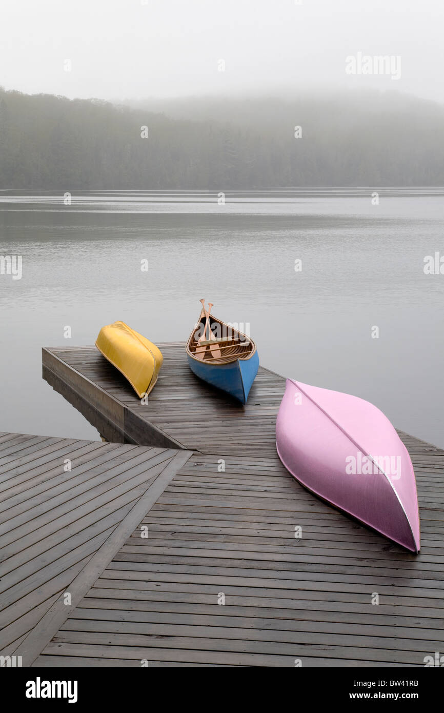 Colourful canoes on dock, Algonquin Park, Ontario Stock Photo