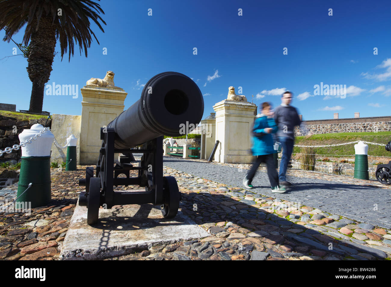 People walking past cannon outside Castle of Good Hope, City Bowl, Cape Town, Western Cape, South Africa Stock Photo