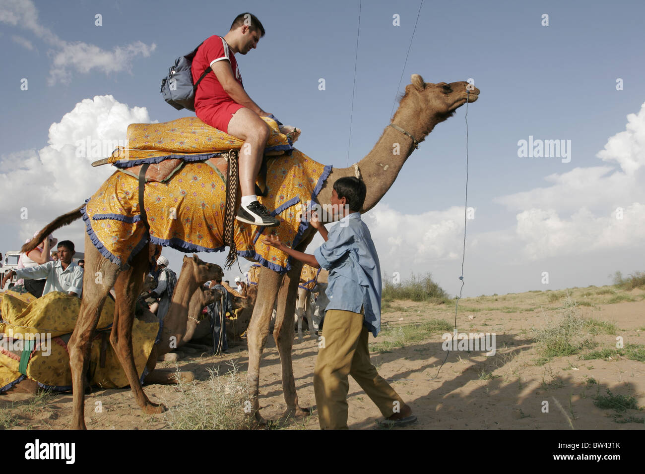 Tourists enjoy a camel ride at Sam, Jaisalmer, Rajasthan, India Stock ...