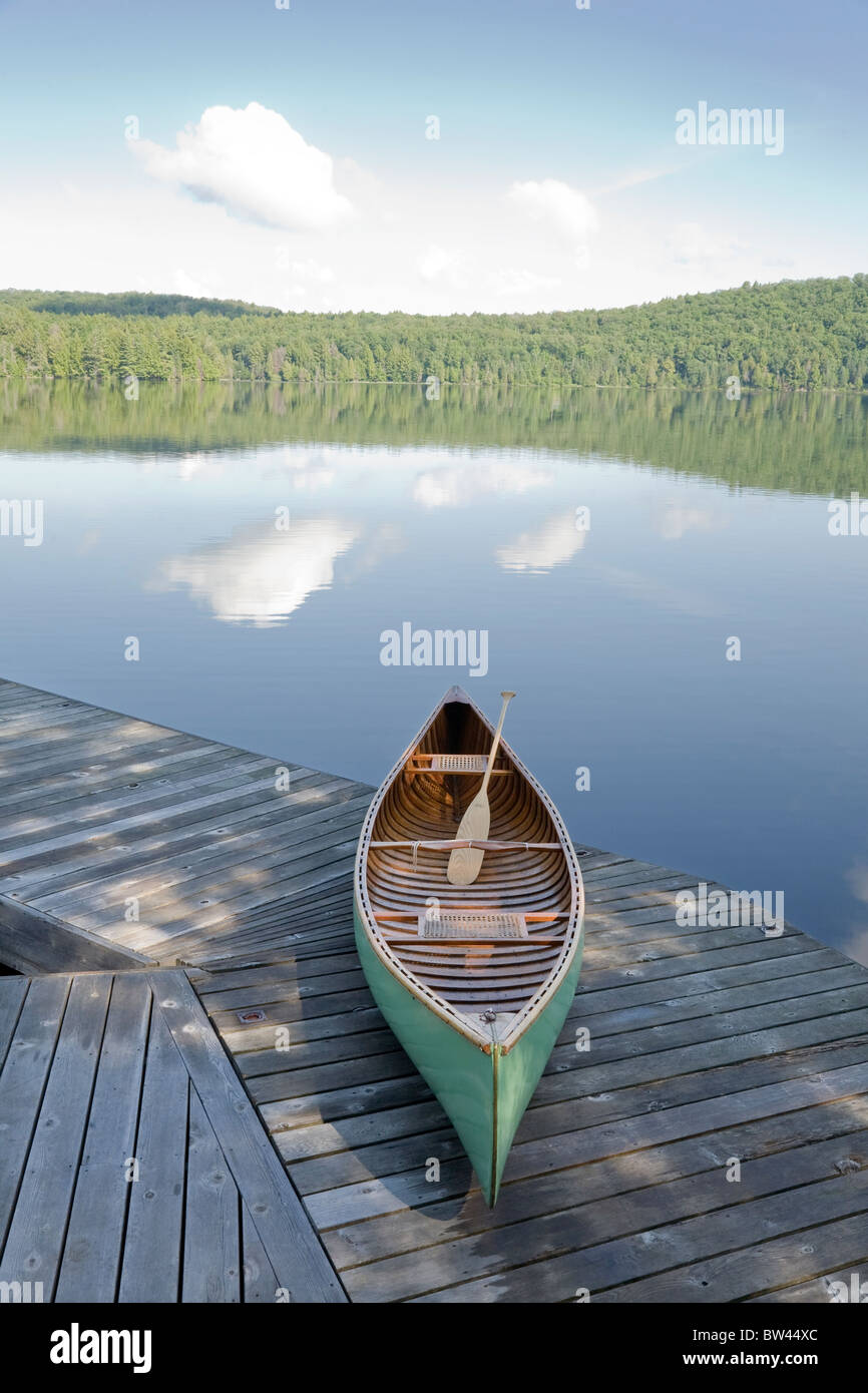 Green canoe on cottage dock, Algonquin Park, Ontario Stock Photo
