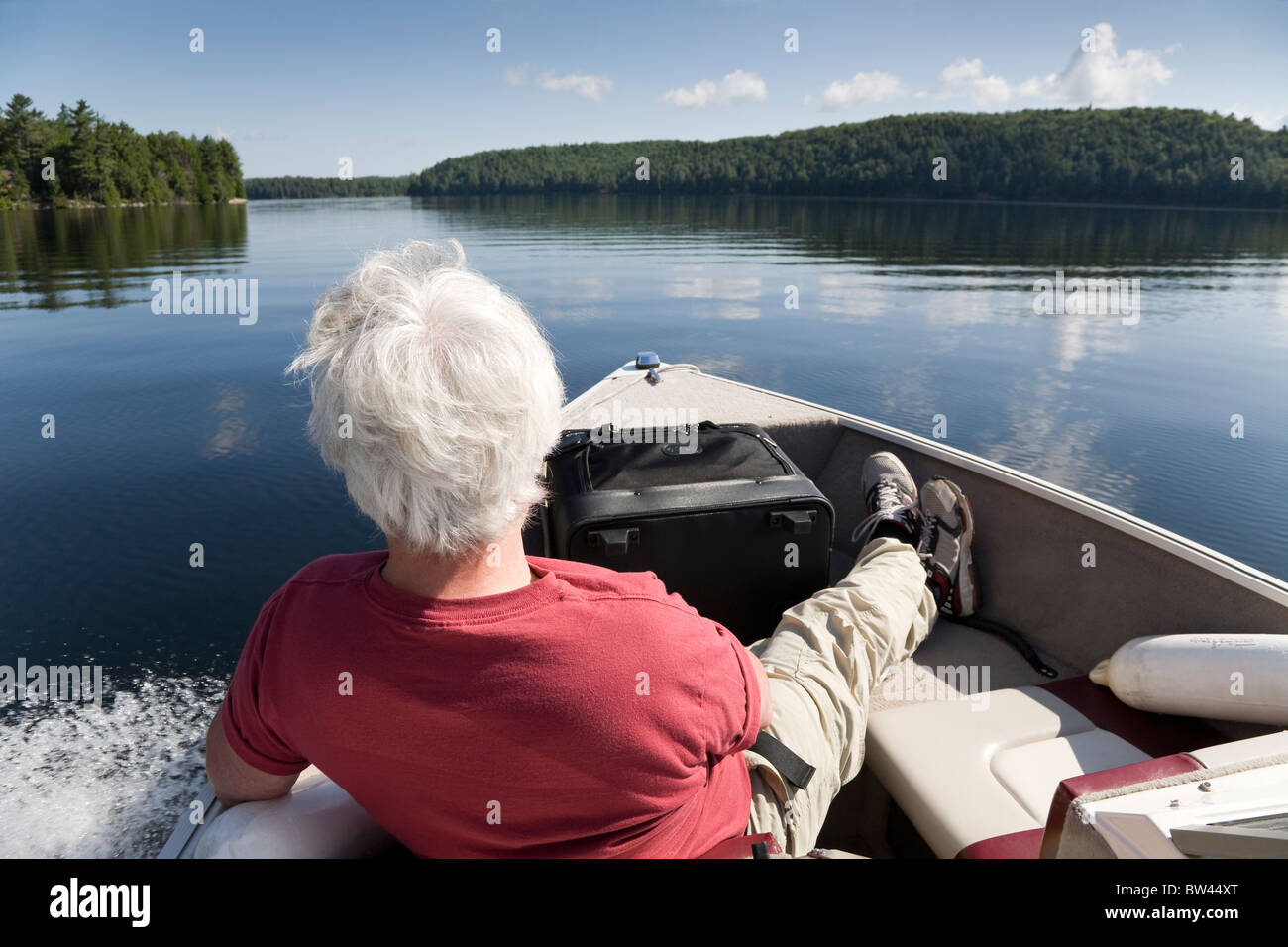 Senior man relaxing while boating, Algonquin Park, Ontario Stock Photo