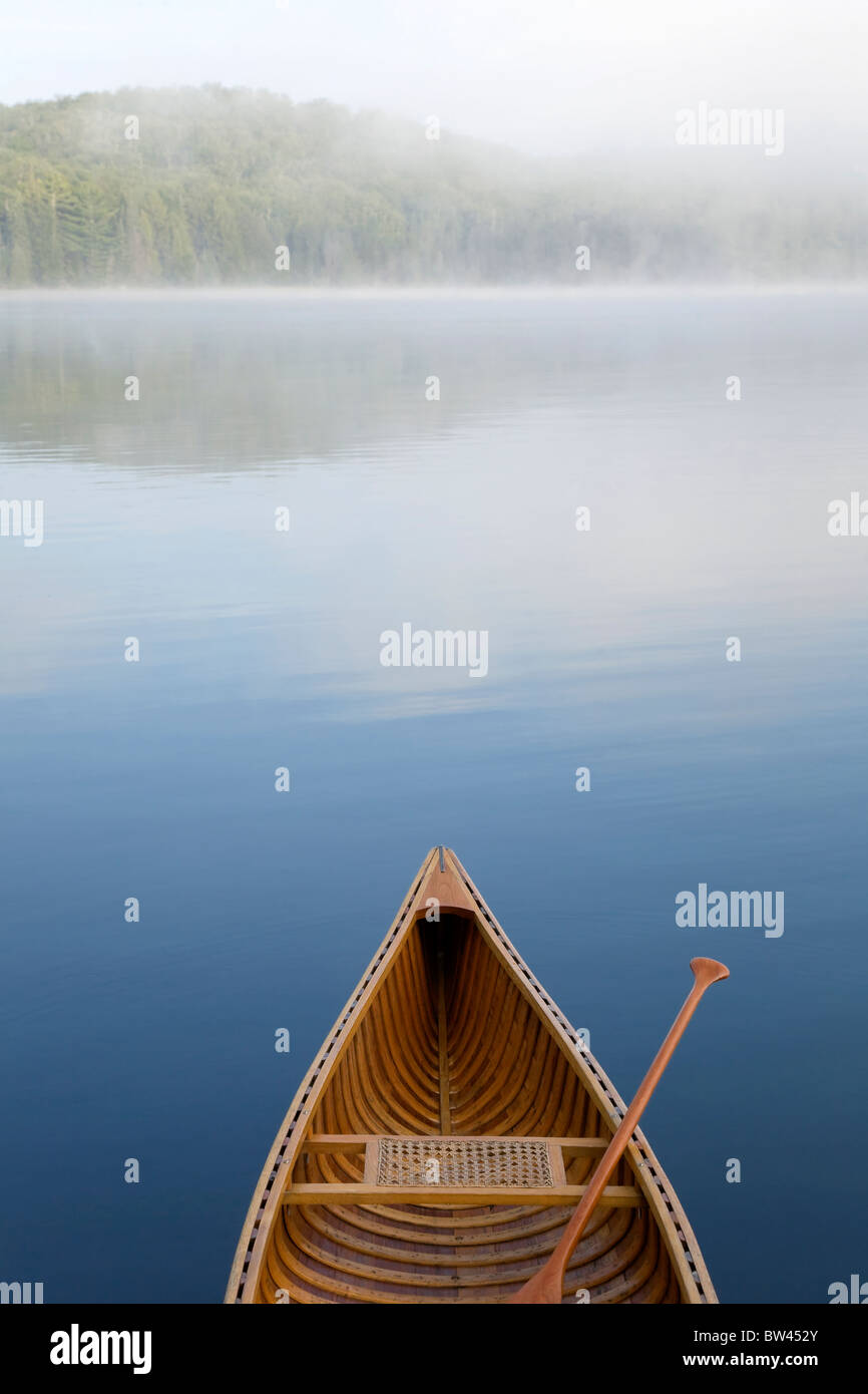 Bow of canoe on calm blue lake, Algonquin Park, Ontario Stock Photo