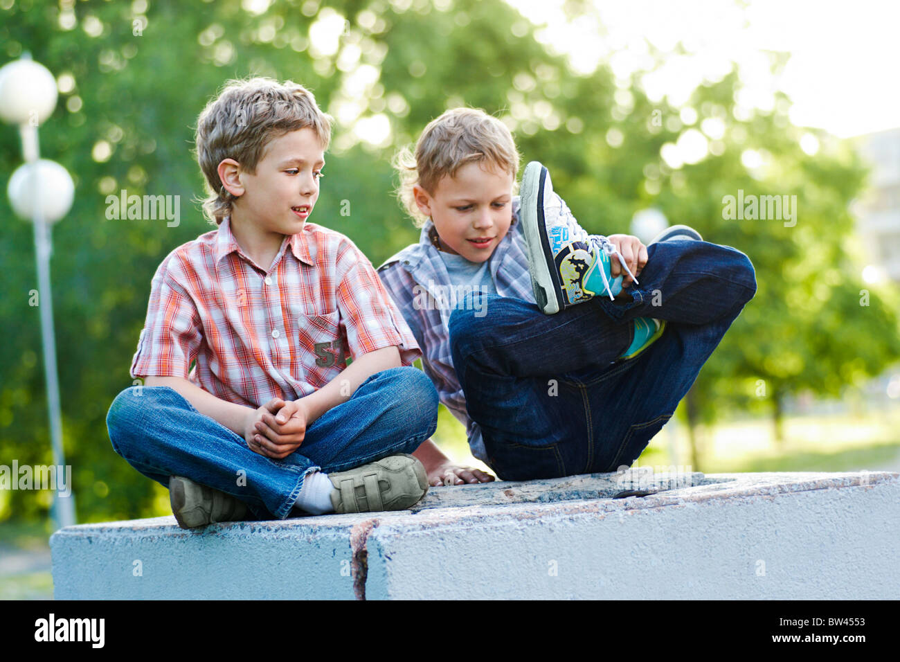 Portrait of two calm kids spending time together outdoors Stock Photo