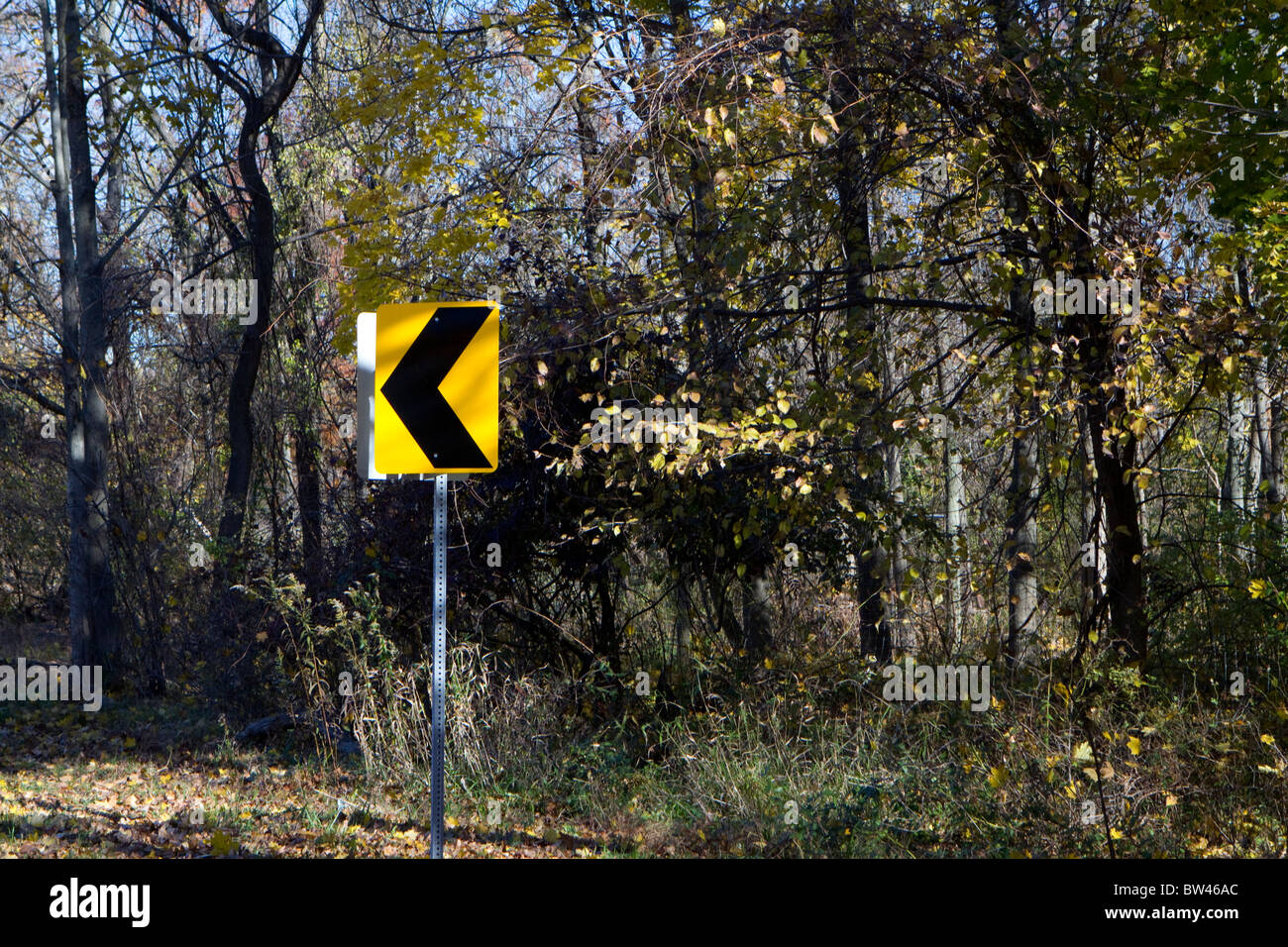 A bend in the road sign. A directional road sign. Driving road sign. Stock Photo