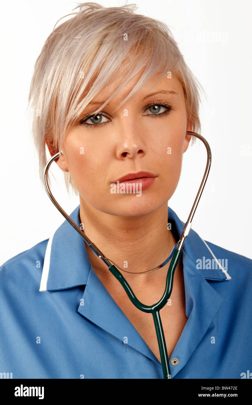 Young female doctor listening through a stethoscope Stock Photo - Alamy