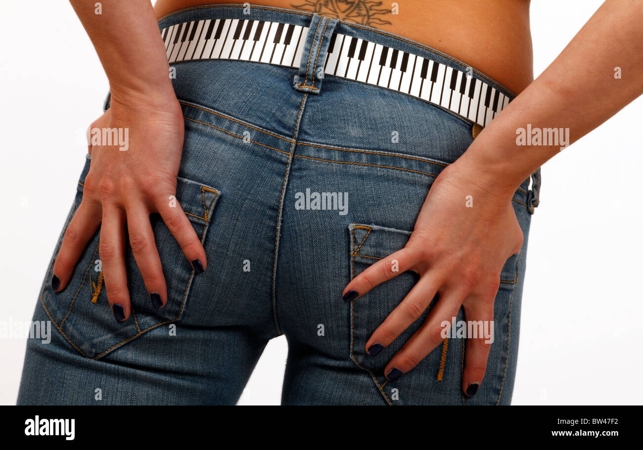 young woman with a tattoo wearing denim jeans with a piano keyboard belt .  Fashion Stock Photo - Alamy