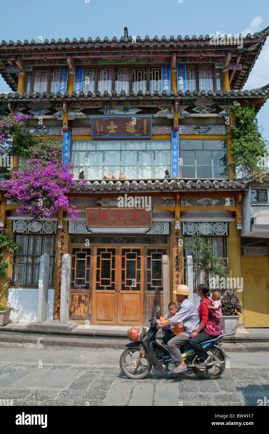 CHINA. FAMILY ON MOTORBIKE IN THE OLD TOWN OF RUILI IN YUNNAN PROVINCE ...