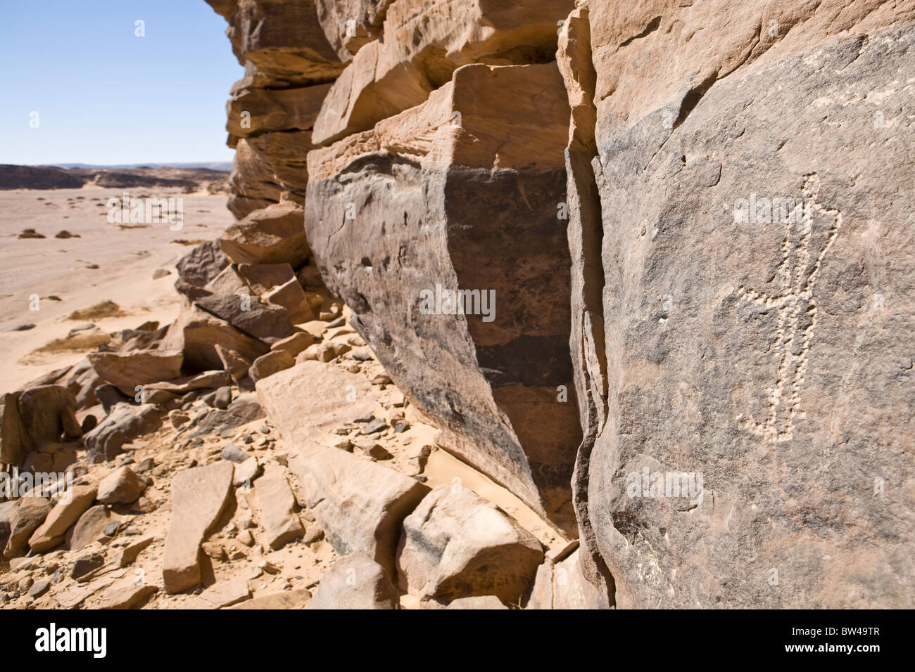Rockart depicting man looking down dry wadi bed in the Eastern Desert of Egypt, North North