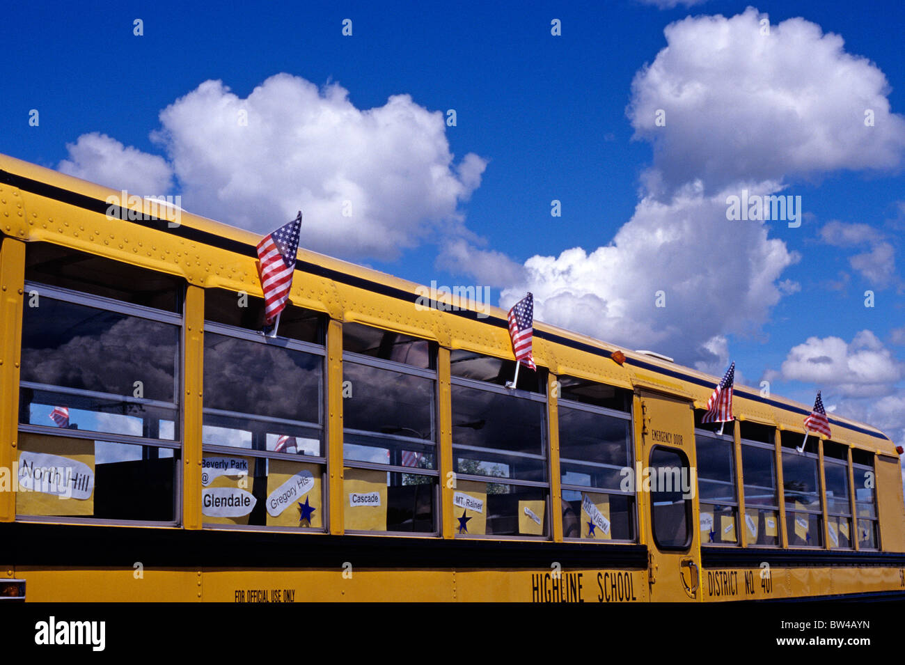 Yellow school bus at 4th of July American flags Stock Photo Alamy