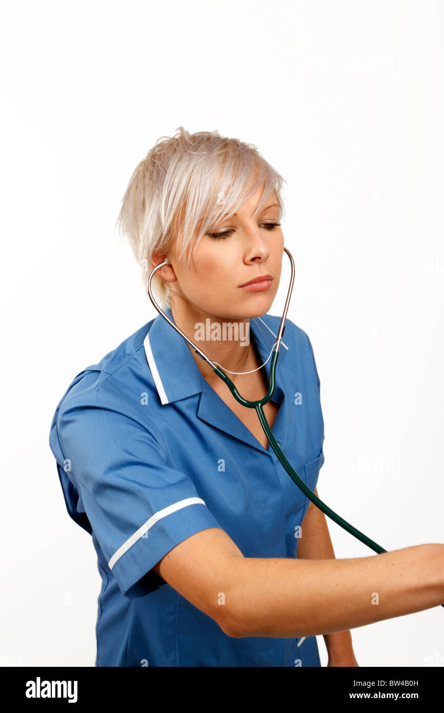 Young female doctor listening through a stethoscope Stock Photo - Alamy