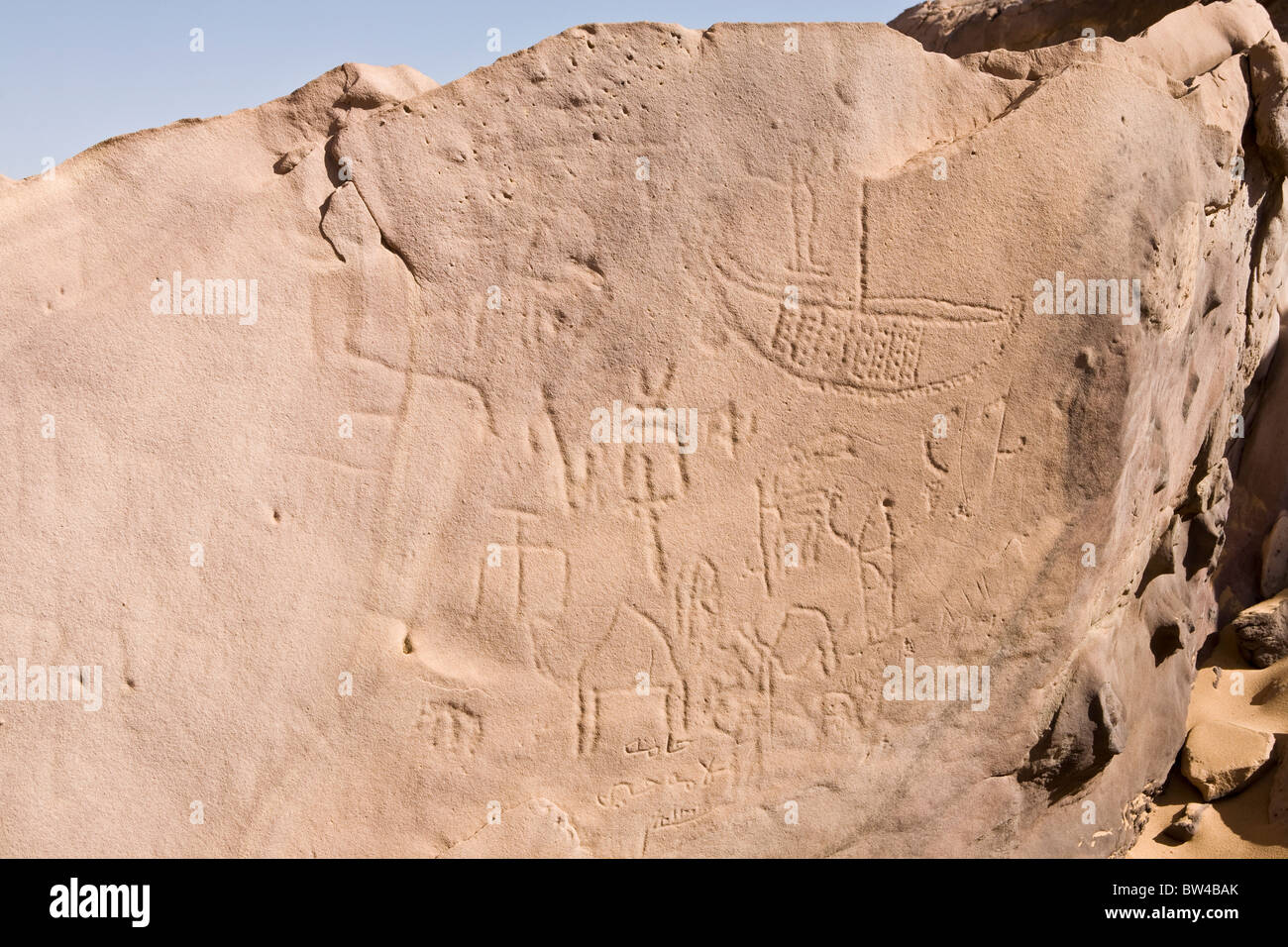 Etchings of various ages of boats, animals and symbols on rock-face in the Eastern Desert, Egypt Stock Photo