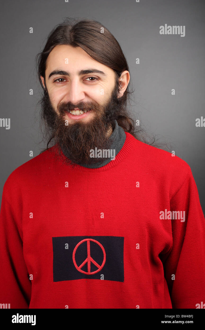 pacifist - peace and love, smiling man with black beard with symbol of peace on his sweater Stock Photo