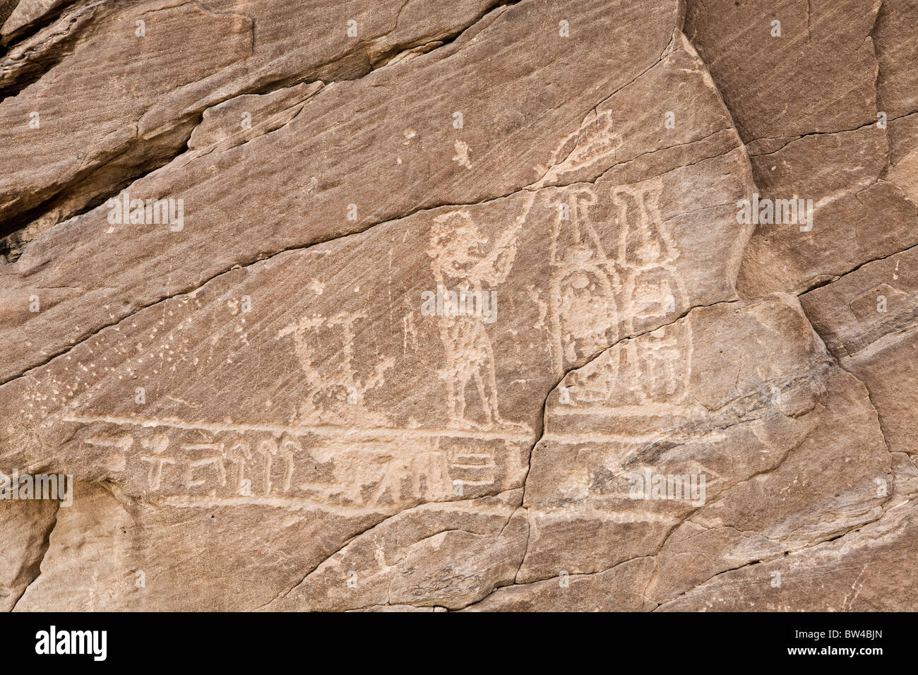 Petroglyph depicting fan bearer before two plumed cartouches on wall in Wadi Hammamat, eastern Desert Egypt Stock Photo