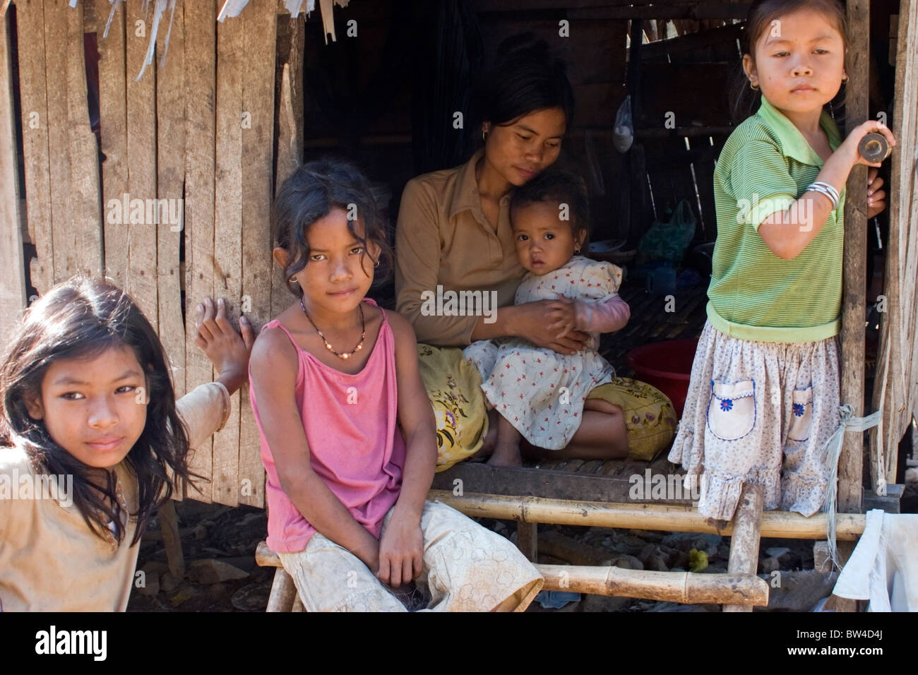 A group of female slum dwellers are living in poverty in a wood shack in  Kampong Cham, Cambodia Stock Photo - Alamy