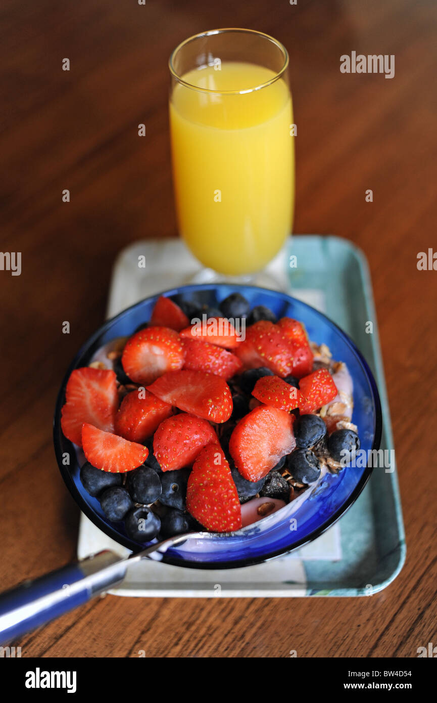 Healthy breakfast of strawberries , blueberries and yogurt with orange juice Stock Photo