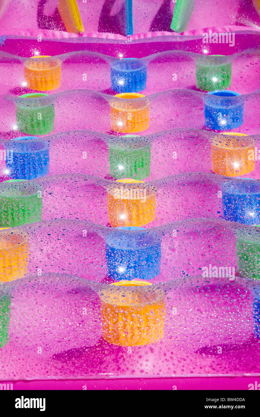 Multicolored airbed close view with refreshing waterdrops Stock Photo