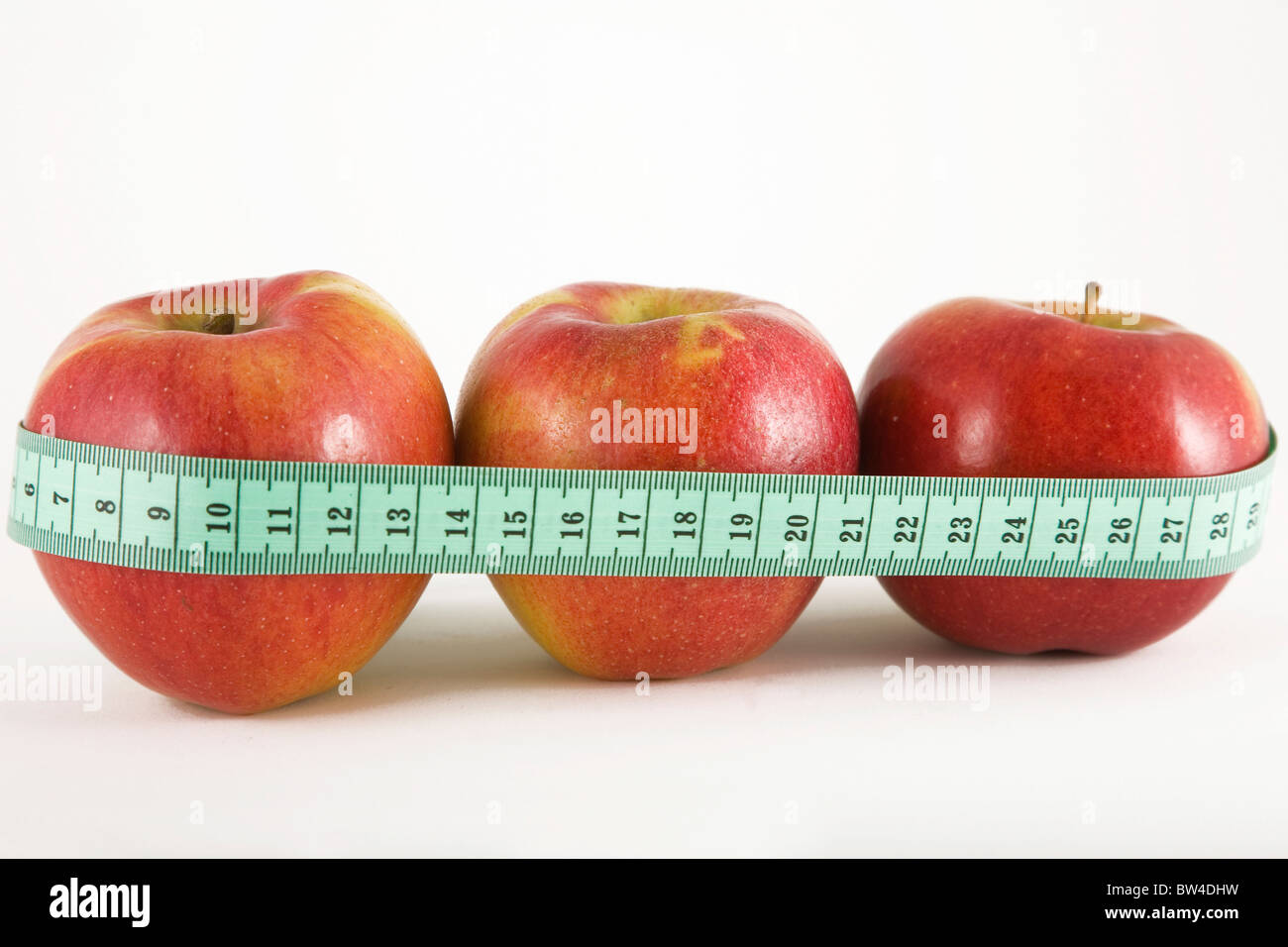 three red apple and green measurement tape, diet and healthy life concept Stock Photo