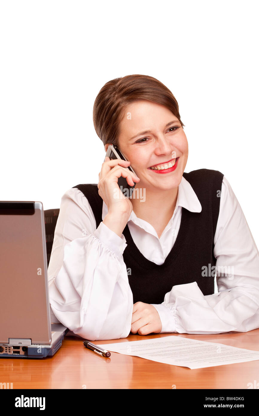 Young happy business woman calling at desk in office. Isolated on white background. Stock Photo