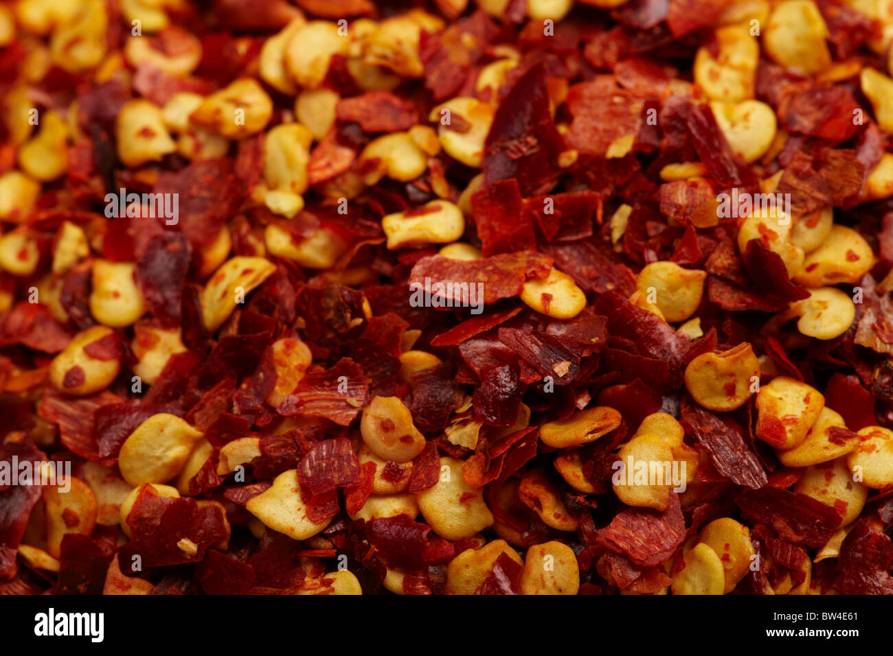 Macro photograph of a large number of dried chilli flakes Stock Photo