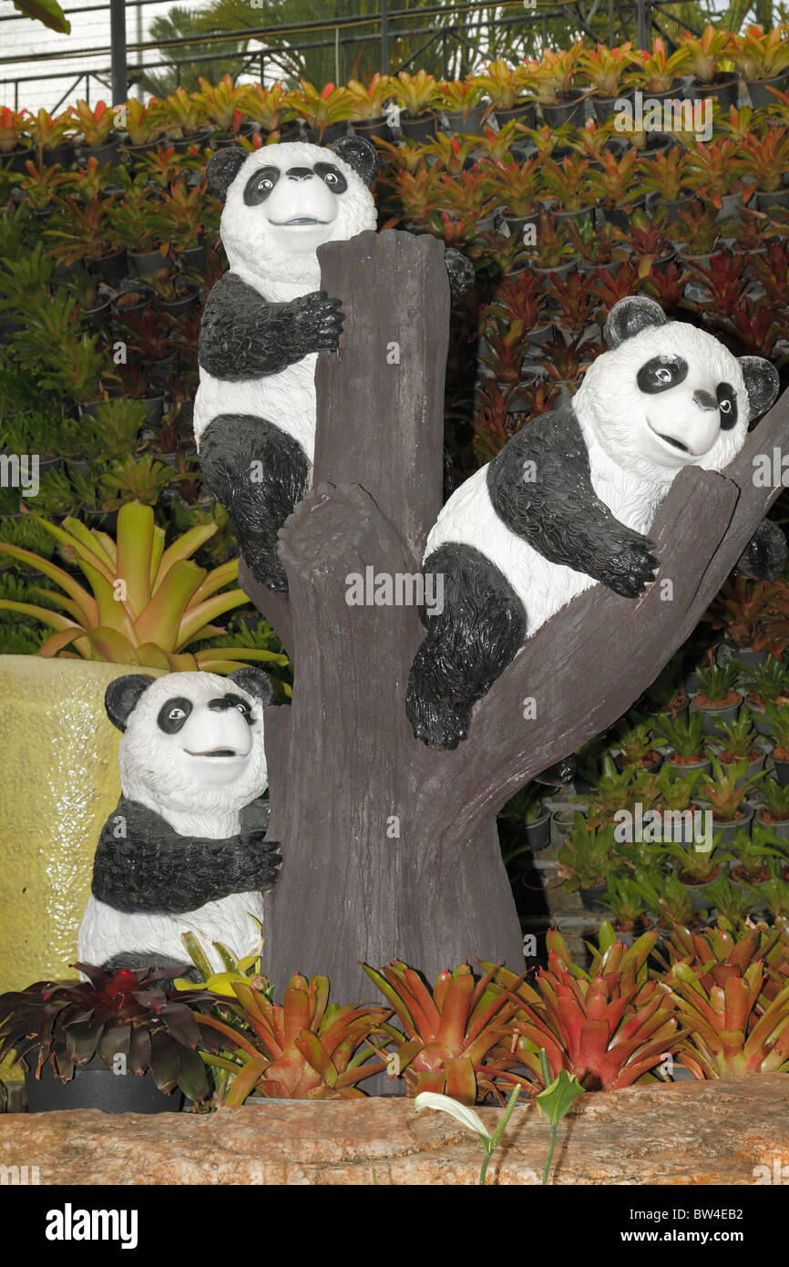 Three Babe (cub, kiddie) Panda mannequins / sculptures on the tree. Nong Nooch Botanical Garden, Pattaya, Thailand October 2010 Stock Photo