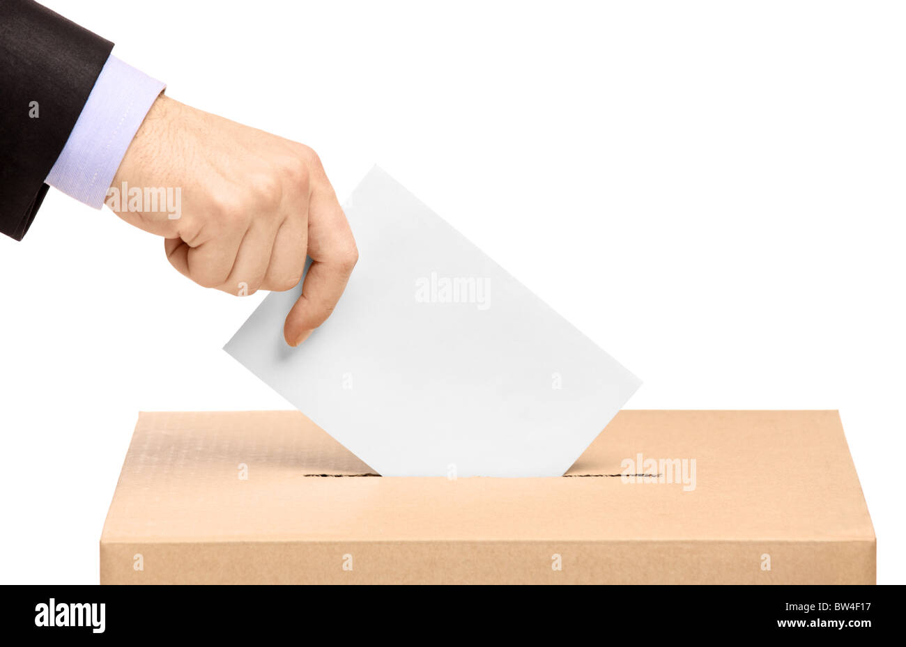 Hand putting a voting ballot in a slot of box Stock Photo