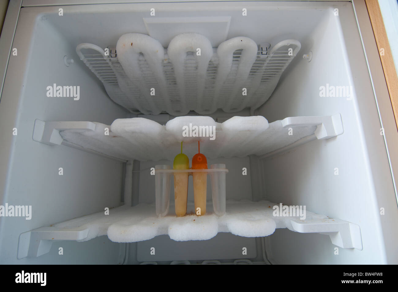 A fridge interior in need of defrosting Stock Photo Alamy