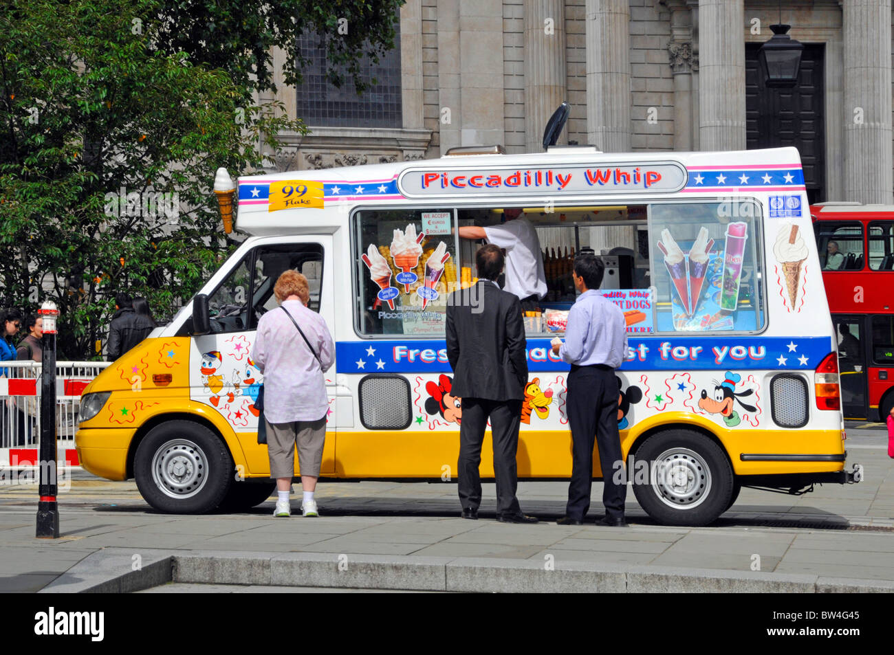 Customers being served at ice cream van a business selling icecream parked outside St Pauls Cathedral City of London England UK Stock Photo