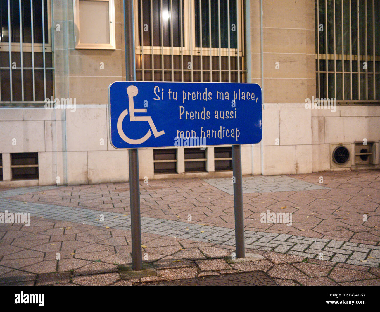 A disabled parking sign in Troyes, France which reads if you take my place,  take my handicap as well Stock Photo