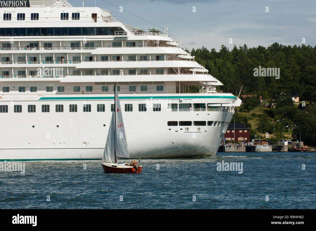 Small sailboats and large ferry Stock Photo