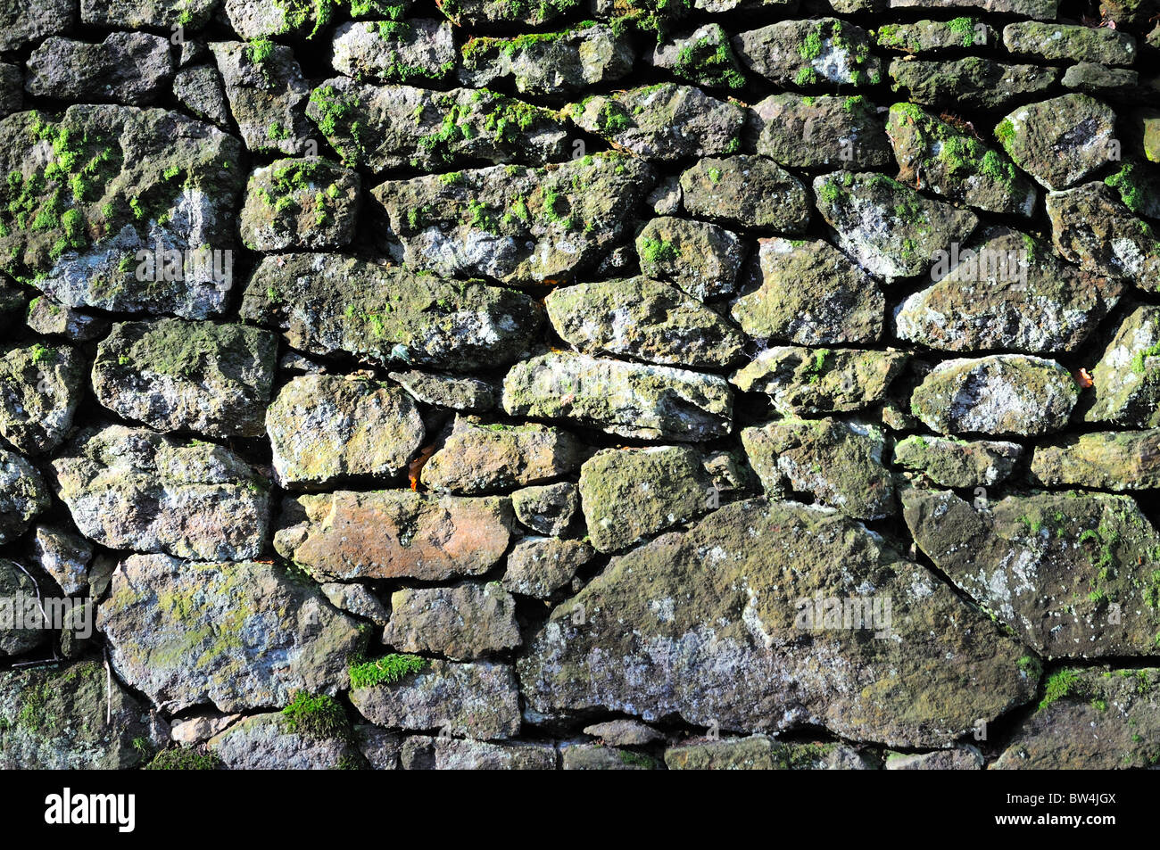 Close up of old natural stone wall Stock Photo - Alamy