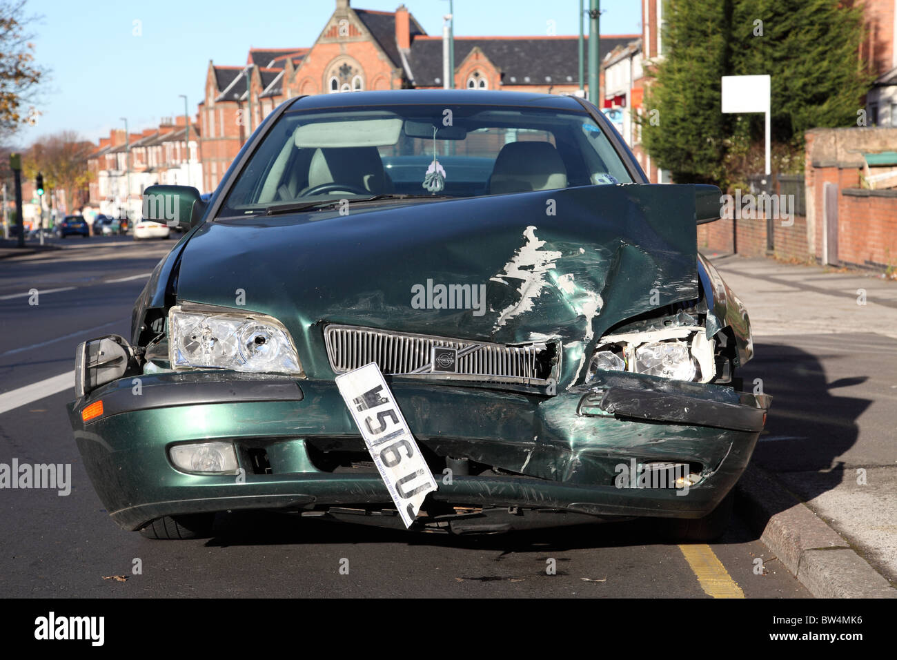 An accident damaged car on a U.K. street. Stock Photo