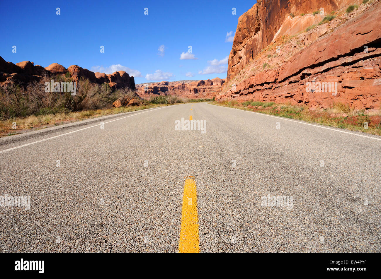 Lonely Desert Highway through Remote Sandstone Canyon Stock Photo