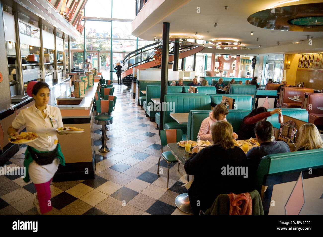 A family on holiday eating breakfast in Annettes Diner, Disneyland  Paris Village France Stock Photo